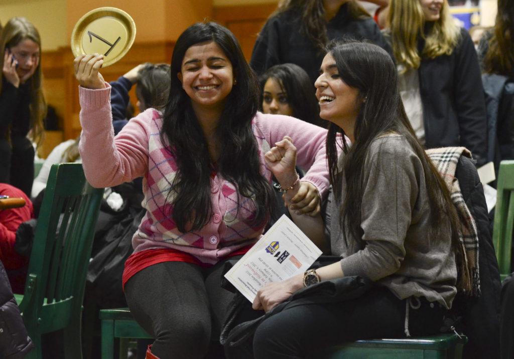 Sophomores Ridhi Arora, left, and Alicia Lalvani, right, wait nervously in Columbian Square after placing an offer for an Ivory Tower double Wednesday evening during the Marthas Marathon auction. The girls won the room with a bid of $3,600. Becky Crowder | Hatchet Staff Photographer
