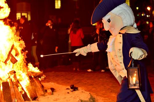 The Universitys mascot roasts a marshmallow during the annual birthday bonfire celebrating George Washingtons birthday. | Hatchet File Photo