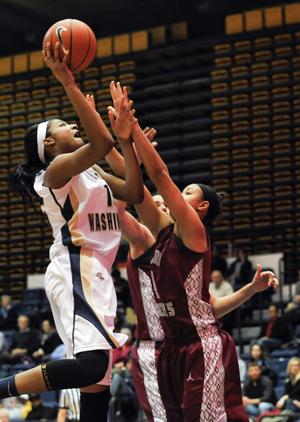 Freshman Anjaleace White goes up for a contested lay-up earlier this season. Hatchet File Photo