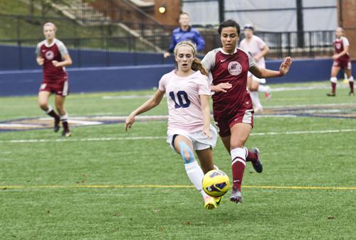 Then-sophomore midfielder Kristi Abbate dribbles by a defender during the 2013 season. Hatchet File Photo by Cameron Lancaster | Contributing Photo Editor