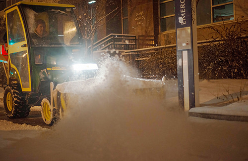 A worker plows the roads and sidewalks on campus Wednesday night. Hatchet File Photo 