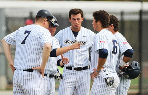 The Colonials discuss strategy in a game against UMass last season. The Colonials split a double-header against NJIT in this seasons opening day on Saturday. | Photo by Zach Montellaro | Hatchet staff photographer