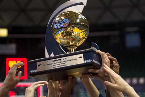 Members of the mens basketball team lift the Diamond Head Classic championship trophy after they defeated No. 11 Wichita State 60-54. Nora Princiotti | Hatchet Staff Photographer