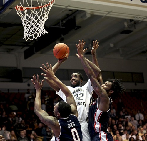 Then-senior forward Isaiah Armwood goes up against Duquesne defenders in a game last season. Hatchet File Photo by Cameron Lancaster | Photo Editor
