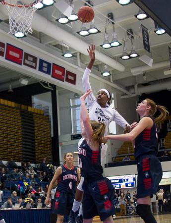 Jonquel Jones shoots over Richmond defenders. Jones had a game-high 21 points and 11 rebounds to lead the Colonials to a 77-67 victory.. Zach Montellaro | Hatchet Staff Photographer