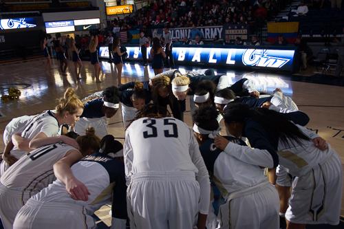 The Colonials form a huddle during pregame introductions in the Smith Center. GW would take down Richmond 77-67. Zach Montellaro | Hatchet Staff Photographer