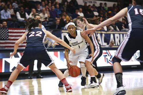 Senior Chakecia Miller dribbles past Duqesnes defense Wednesday night. The Colonials squashed the Dukes 83-56, remaining undefeated in conference play. Cameron Lancaster | Photo Editor