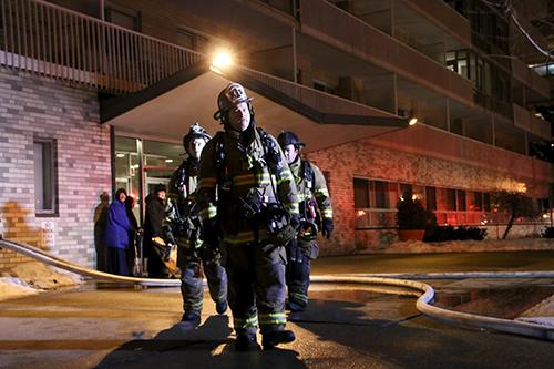 Firefighters exit Potomac Plaza Terraces, after residents were evacuated Sunday night due to an oven fire on the sixth floor. Desiree Halpern | Contributing Photo Editor