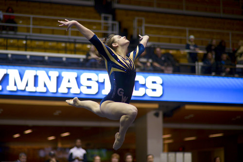 Freshman Jillian Winstanley leaps into the air as she completes her floor routine. 