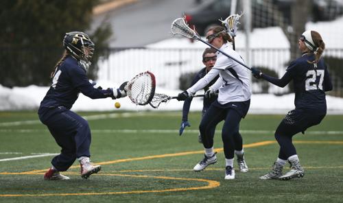 Senior attacker Jamie Bumgardner works the net in a game earlier this season. Bumgardner dished out seven assists as the Colonials took down Mount Saint Marys on Tuesday, a new program record.  Cameron Lancaster | Photo Editor