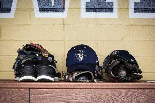 Hats, gloves and shoes line the Colonials bench. Dan Rich | Contributing Photo Editor