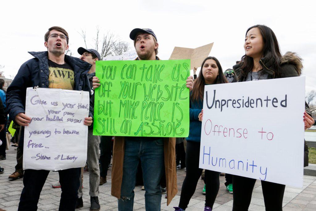 Juniors Henry Manning, Connor Skeens and Alaina Pak protest Trumps ban on immigration from seven Muslim-majority countries outside the Capitol building Sunday.