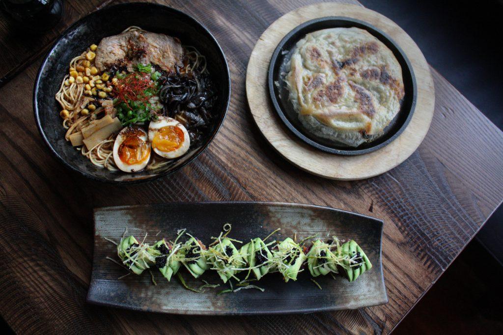 Tonkitsu spicy miso ramen (top left), pork goyza (top right) and black snake roll (bottom center) are included in Rakuyas Restaurant Week menu.