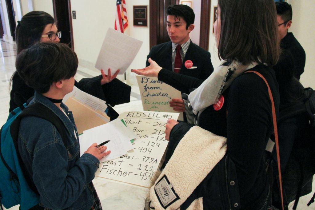 Clockwise from bottom left: Sophomore Bonnie Zucco, sophomore Nora Hennessey, junior Kei Pritsker and sophomore Cara Schiavone organize in the halls of the Russell Senate Office Building before delivering letters to senators outlining their concerns about Betsy DeVos, the Secretary of Education nominee.