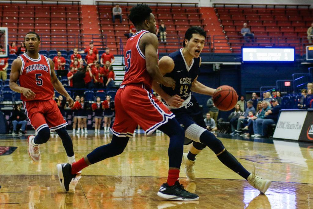 Junior guard Yuta Watanabe dribbles the ball during Suday's men's basketball game at Duquesne. Watanabe held the Dukes' top scorer, Mike Lewis II, to only five first half points.