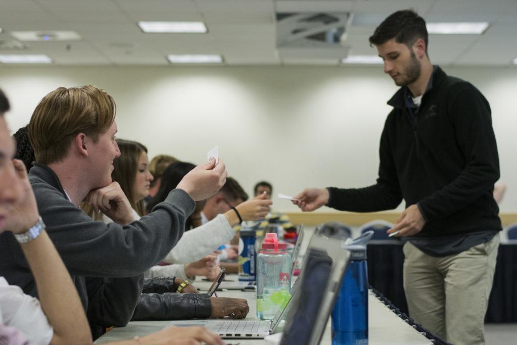 Ezra Alltucker, Chief of Staff to SA President-elect Peak Sen Chua, collected ballots as the SA Senate-elect voted to approve executive cabinet nominees for next academic year.