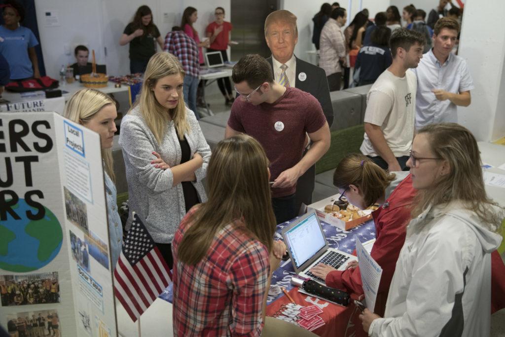 From right to left: Gage Cohen, director of publications; Sara Dougherty, director of public relations and Caroline Sayers, director of membership promote College Republicans using their new recruitment strategy at the student organization fair Saturday.