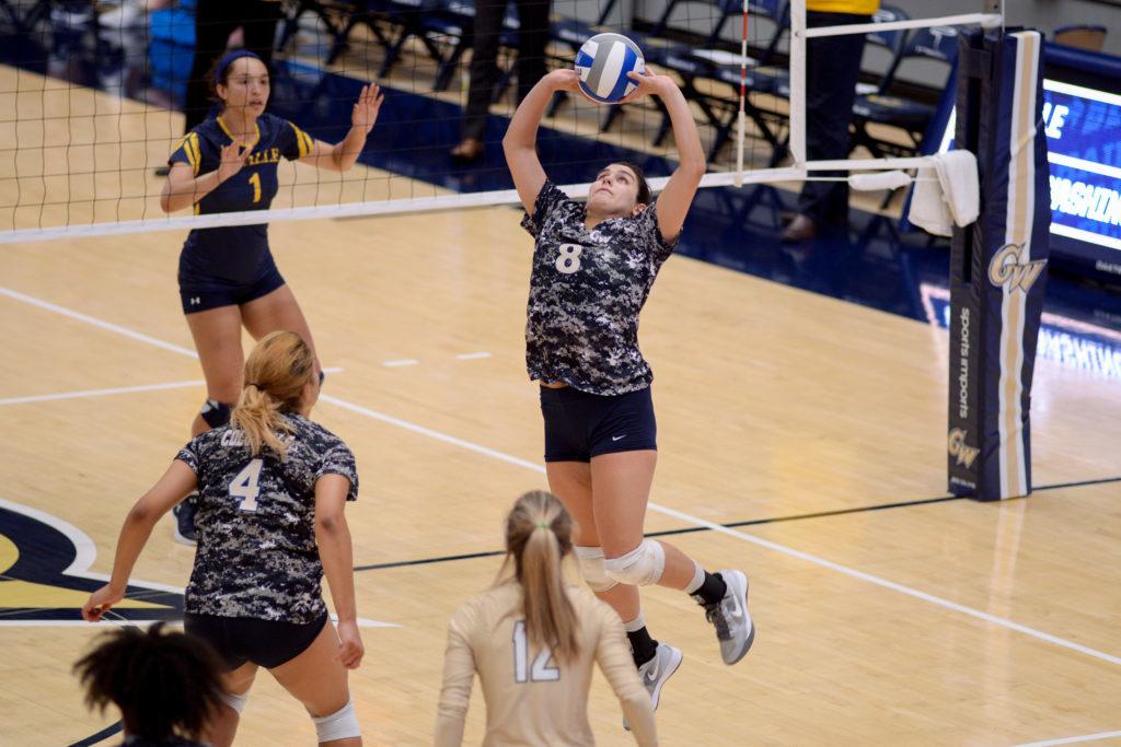 Graduate student setter Stacey Benton sets the ball during volleyballs Saturday night game against La Salle.