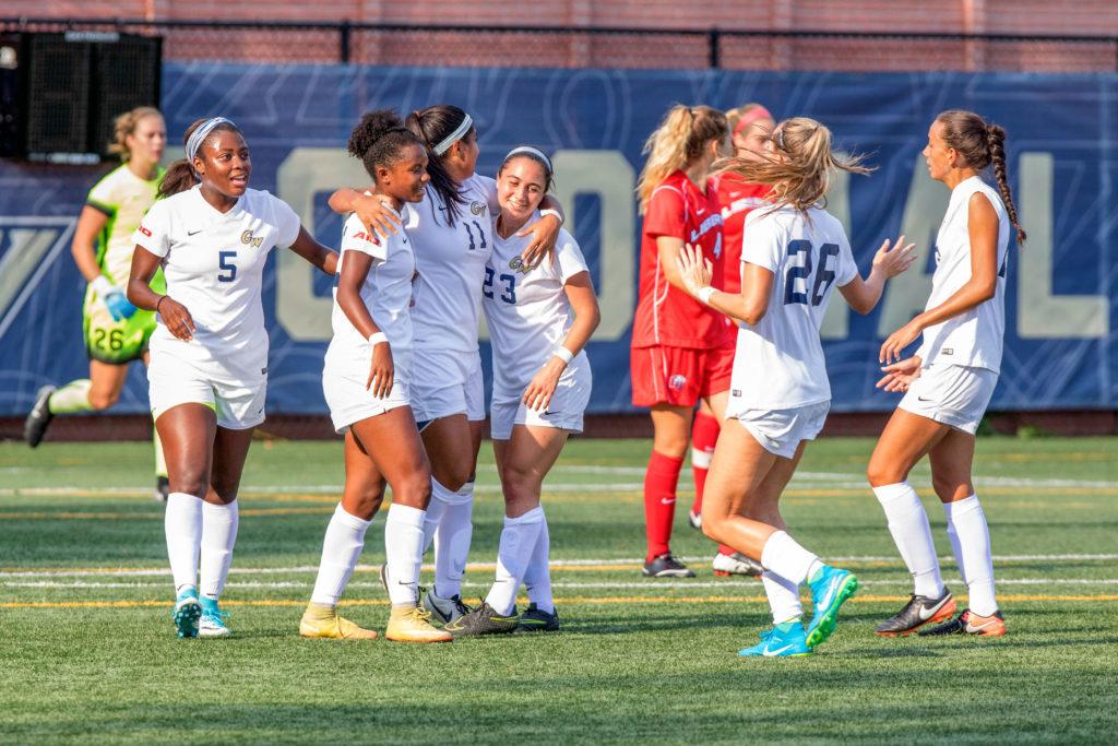 Women’s soccer players celebrate a goal during the team’s game against Liberty in August.