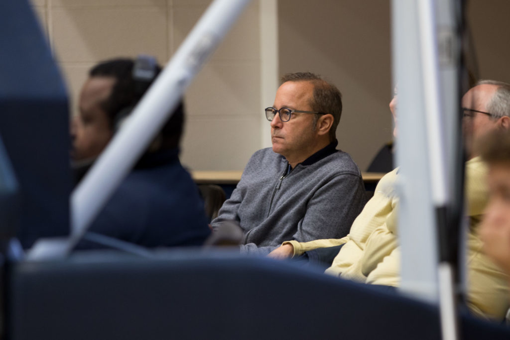 Athletic director Patrick Nero sits on the sidelines of a womens basketball game Sunday. Neros former executive assistant alleged his treatment of her was in violation of Equal Pay Act and Title VII laws in an EEOC lawsuit against the University.
