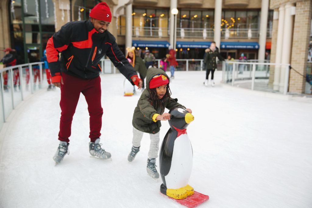 Tysheron Grant skates with his son, Cody, at the Washington Harbour Ice Rink.