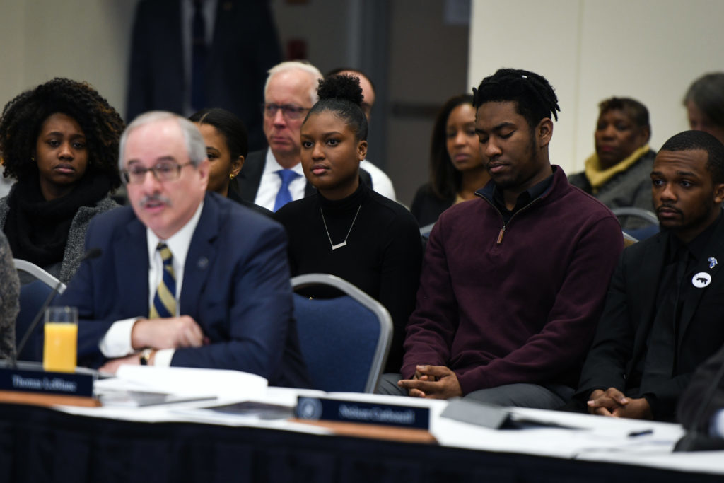 Black student leaders sat behind University President Thomas LeBlanc and members of the Board of Trustees at Friday's meeting.