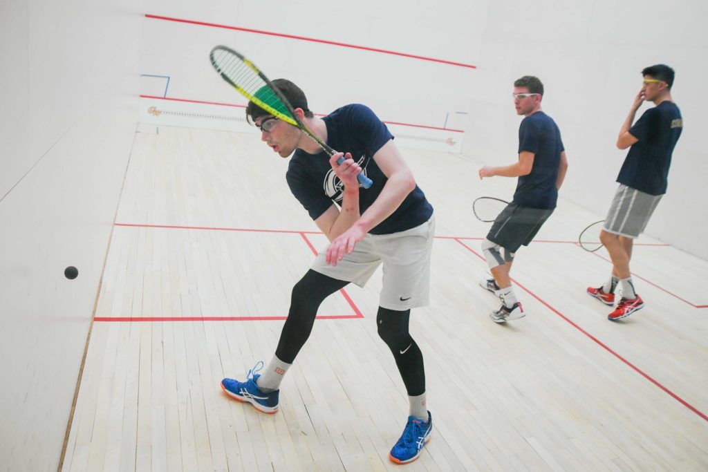 Senior Oisin Logan prepares to return a ball during a squash practice in January.