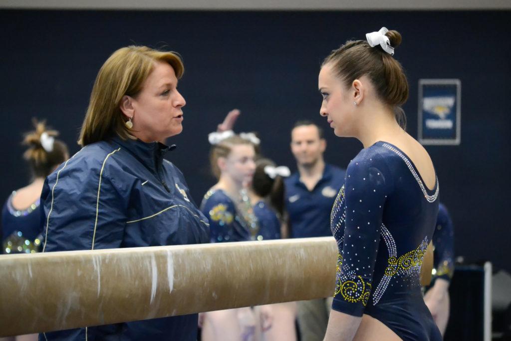 Margie Foster-Cunningham speaks to a gymnast in 2018.