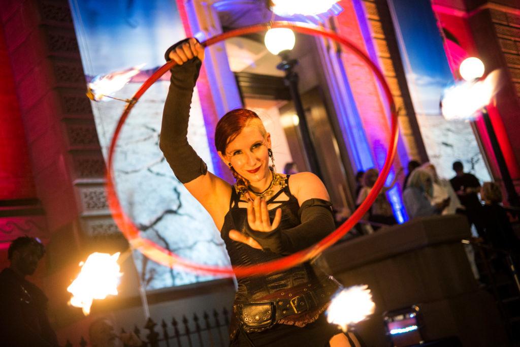 Kyle, a fire spinner and member of Cast of Thousands who declined to give her real name, performs outside the Renwick Gallery's “No Spectators” exhibit Thursday.