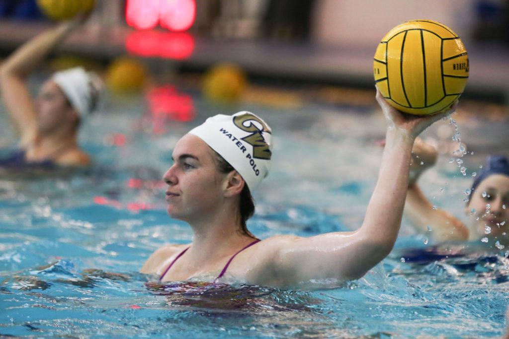 Senior utility player Scarlett Hallahan throws the ball at a women's water polo practice earlier in April. 