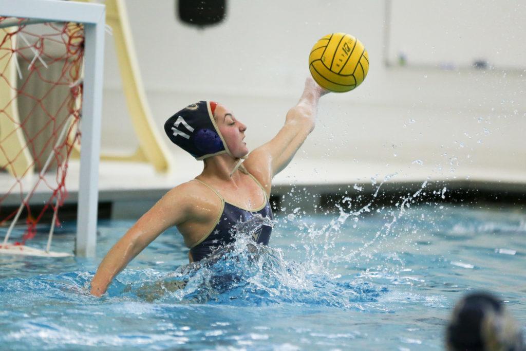 Sophomore goalkeeper Samantha Runyon deflects a shot at a women's water polo practice Thursday.