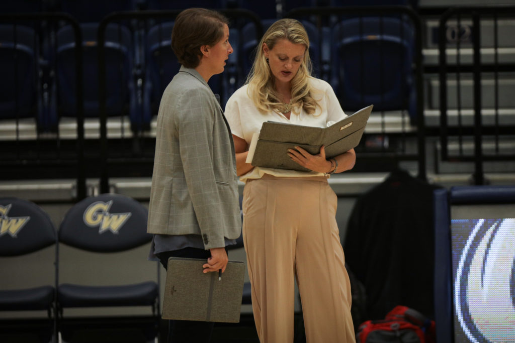 Head coach Sarah Bernson stands next to assistant coach Nicole Cervantes during a game against American Saturday. 