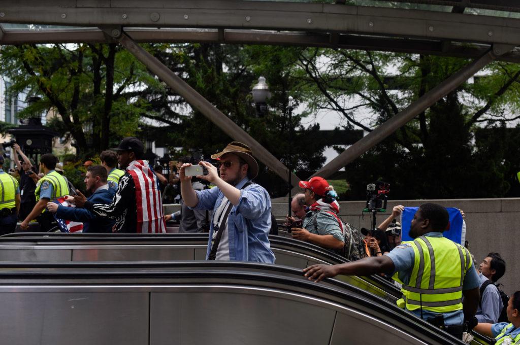 About 25 protesters, led by demonstration organization Jason Kessler, take an escalator out of the Foggy Bottom Metro Station during Unite the Right 2 Sunday.