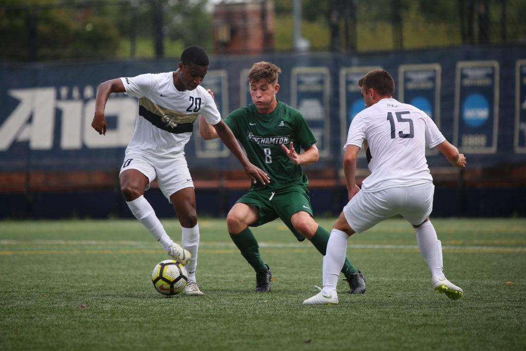 Freshman+midfielder+Alhaji+Turay+holds+the+ball+away+from+a+Binghamton+defender+during+a+mens+soccer+game+last+week.+