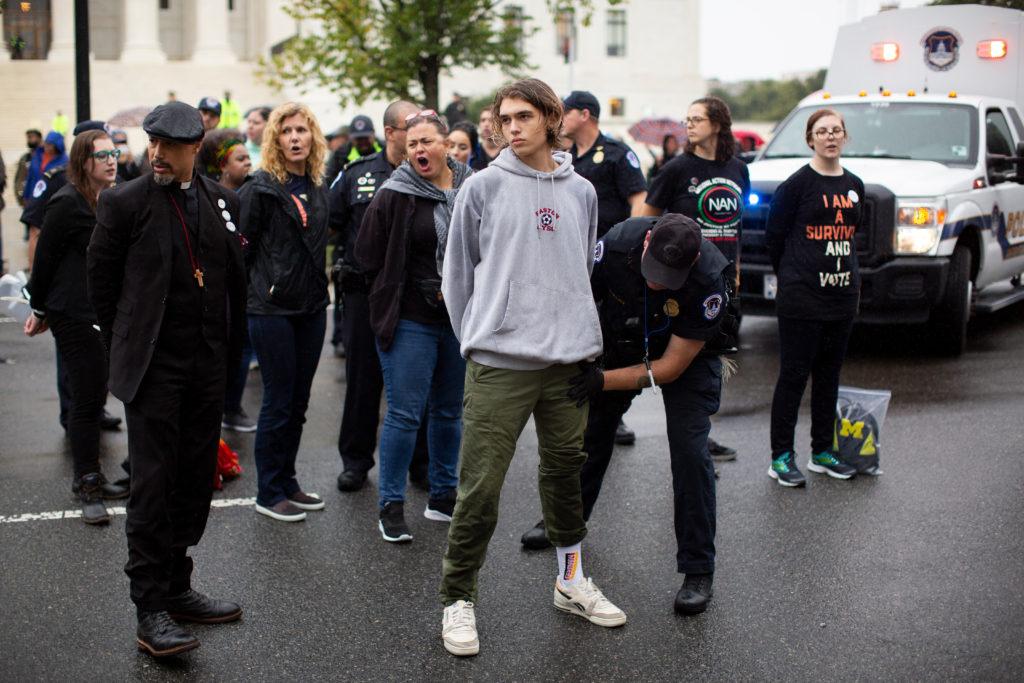 Freshman+Owen+Hall+stands+in+the+rain+after+being+arrested+protesting+against+Supreme+Court+nominee+Brett+Kavanaugh%2C+who+has+been+accused+of+sexual+assault%2C+Thursday.+