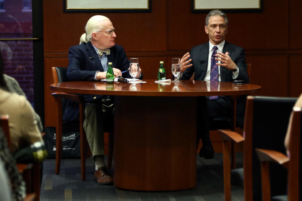 John Whealan, the intellectual property advisory board associate dean for intellectual property law studies, left, speaks with U.S. Patent and Trademark Office Director Andrei Iancu at the law school Wednesday.