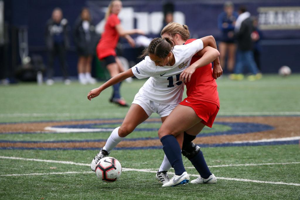 Freshman midfielder Marina Pareja fights with a Dayton player for the ball during Sundays match. 