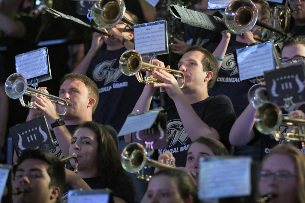 A group of musicians, including members of the Colonial Brass, work together to provide the soundtrack during sporting events in the Smith Center. 