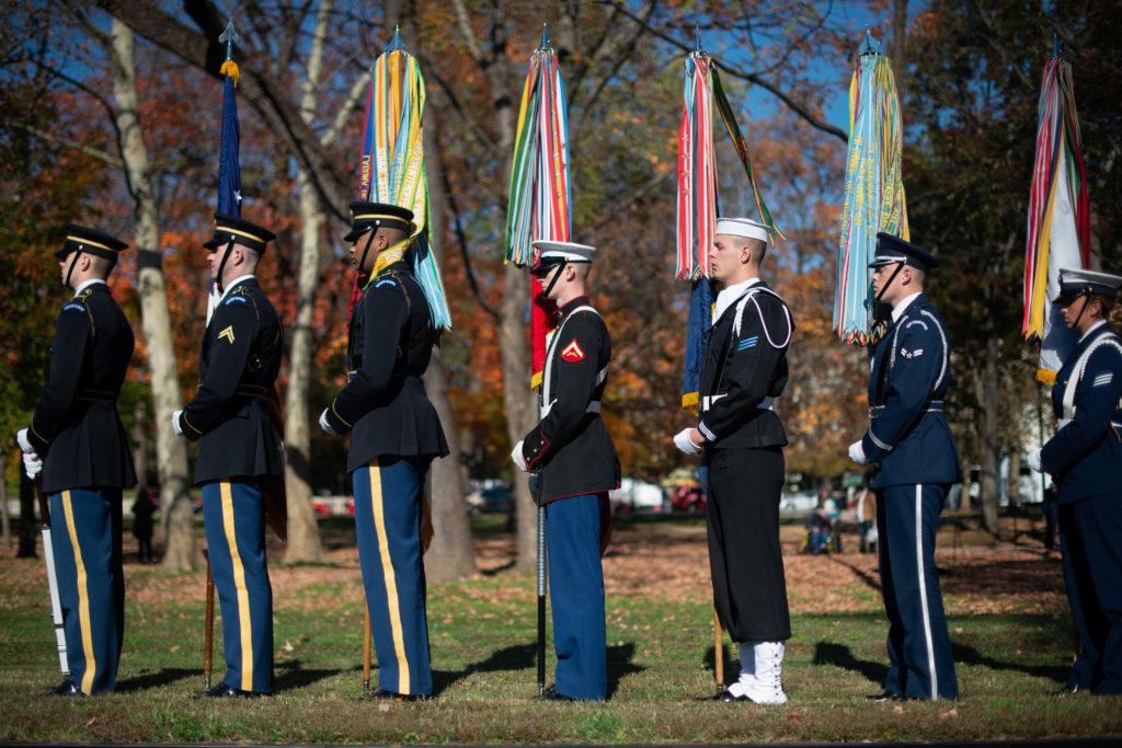 A joint unit color guard stands before the rememberance program at the Vietnam Veterans Memorial for Veterans Day. 