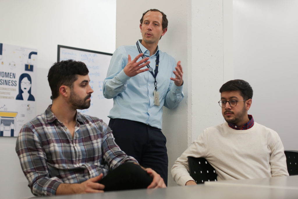 Chris Perry, a second year graduate student, Andy Ludwig, the staff adviser for the engineering group, and second year graduate student Kushal Malvania are three of the people working to make Amsterdam Hall more sustainable. 
