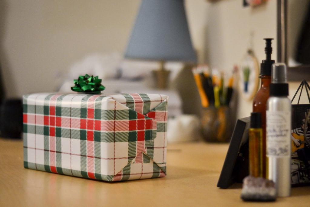 A wrapped gift sits atop a students desk. 