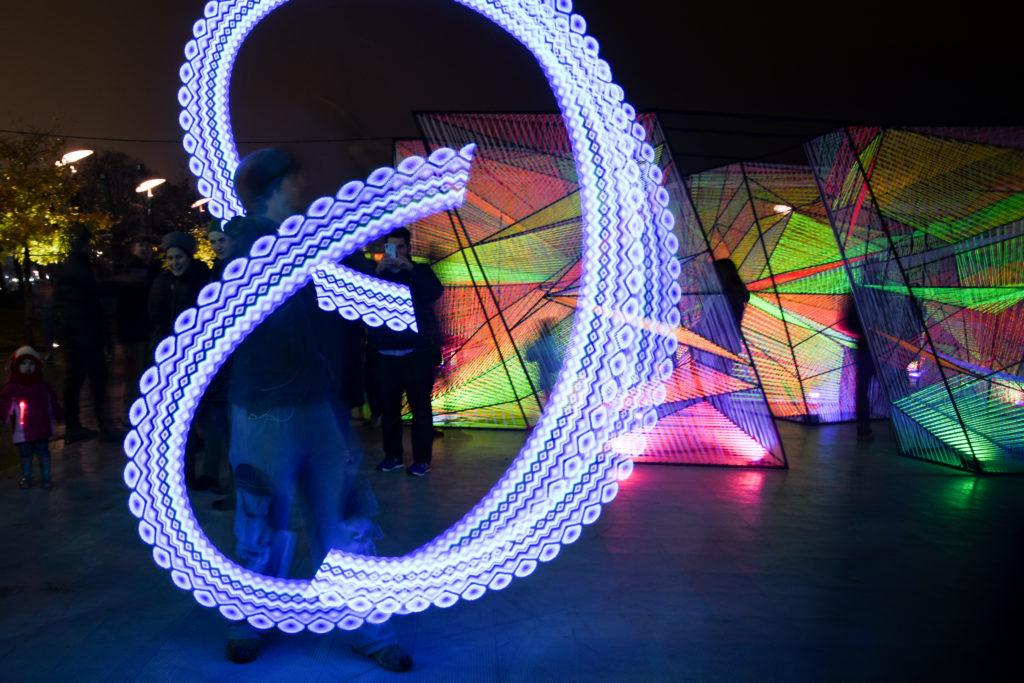 Ben Drexler spins a poi – a tethered weight that can be spun through the air – that displays custom light designs at the Georgetown Glow outdoor exhibit Saturday. 