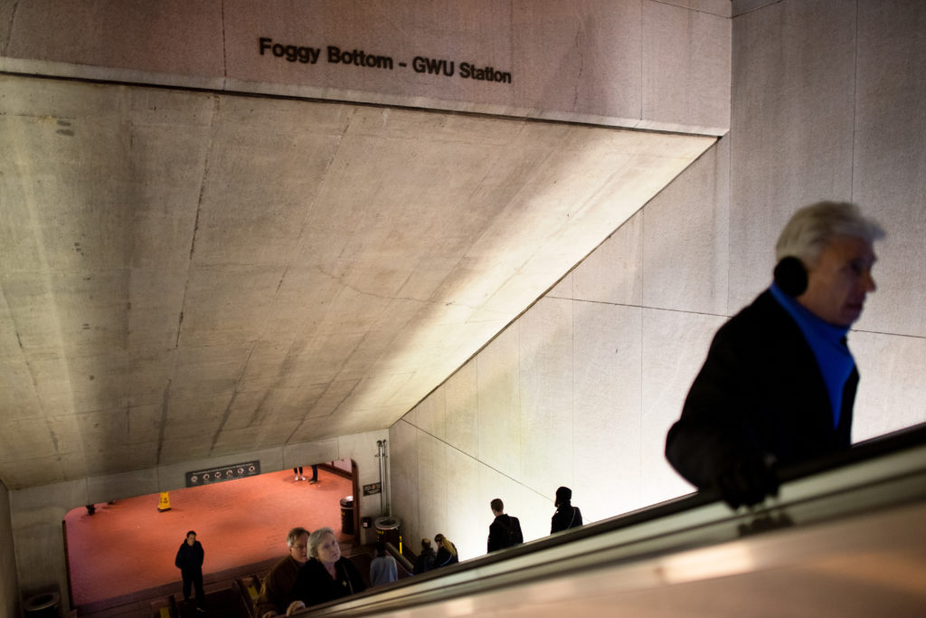 Commuters pass through the Foggy Bottom Metro entrance.