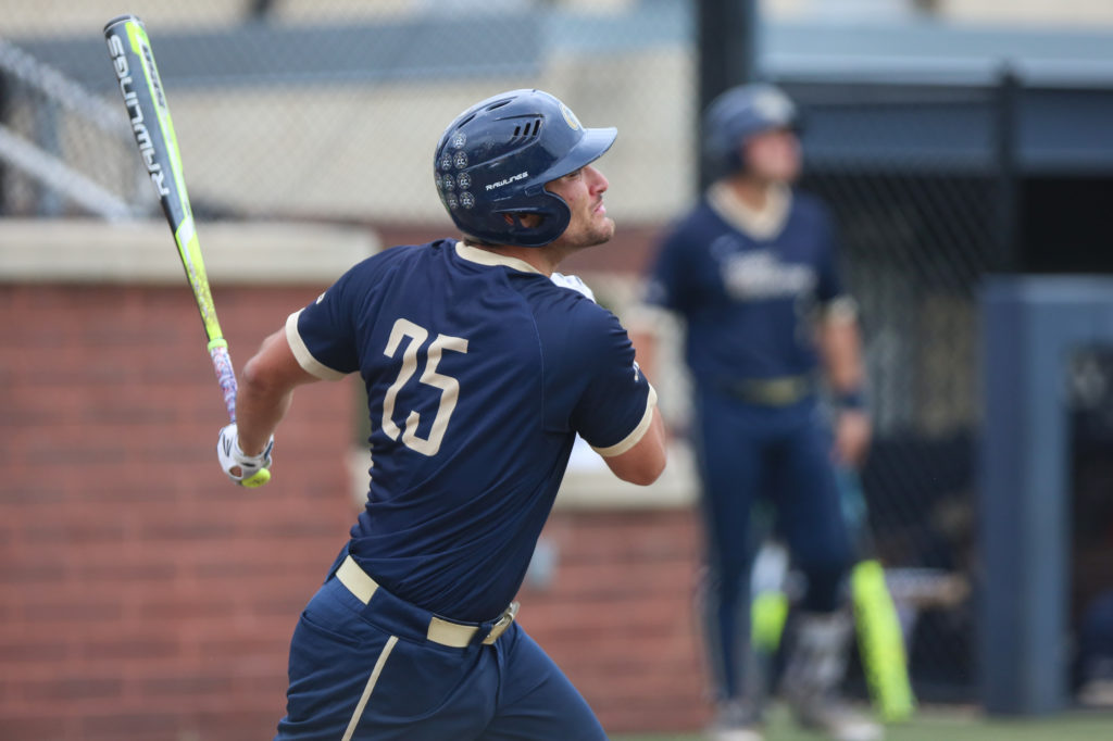 Senior utility player Dom D’Alessandro swings at a pitch during a baseball game last spring. 