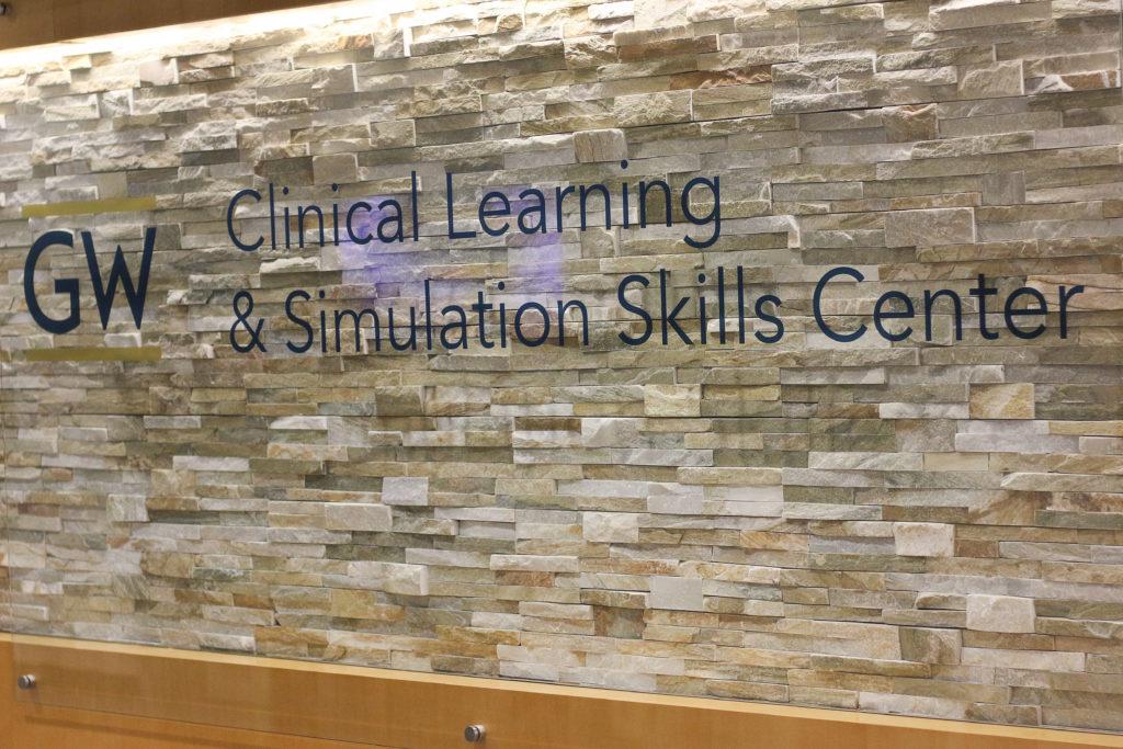 The School of Medicine and Health Sciences provides simulated clinical training for patient interactions, maintaining a goal set in 2012 to offer clinical spaces for student practice.  