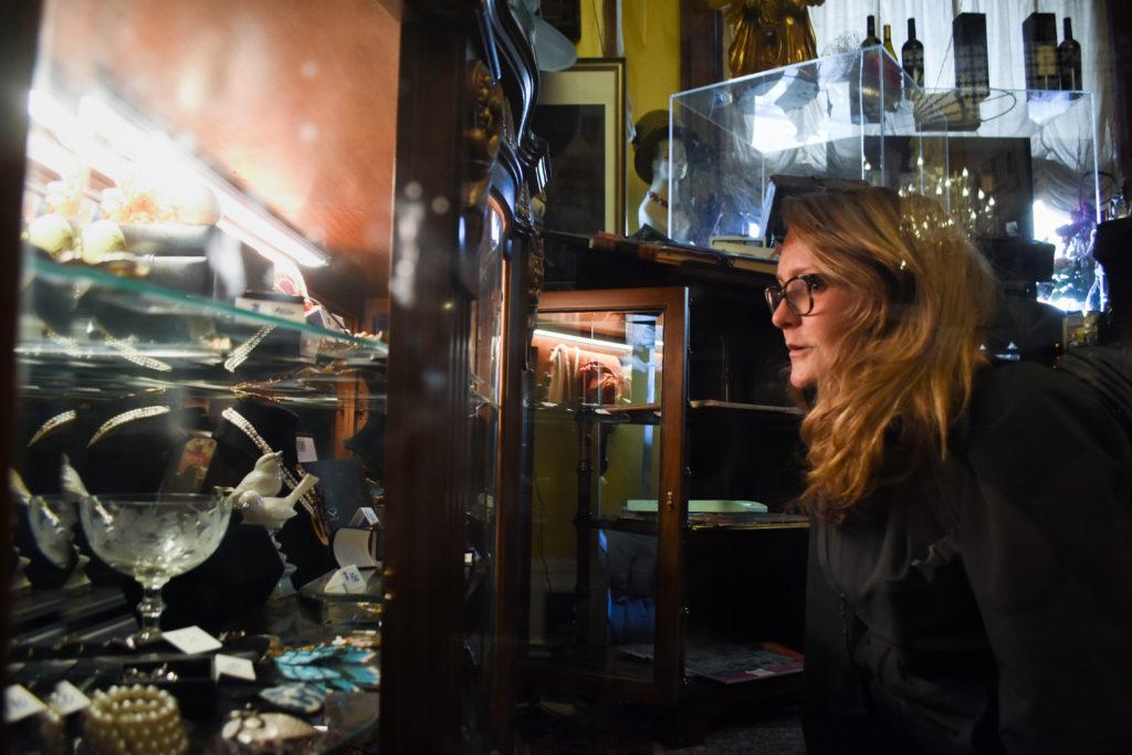 Sharon Eliza Nichols looks at a display case filled with jewlery and trinkets at the Mansion on O Street.