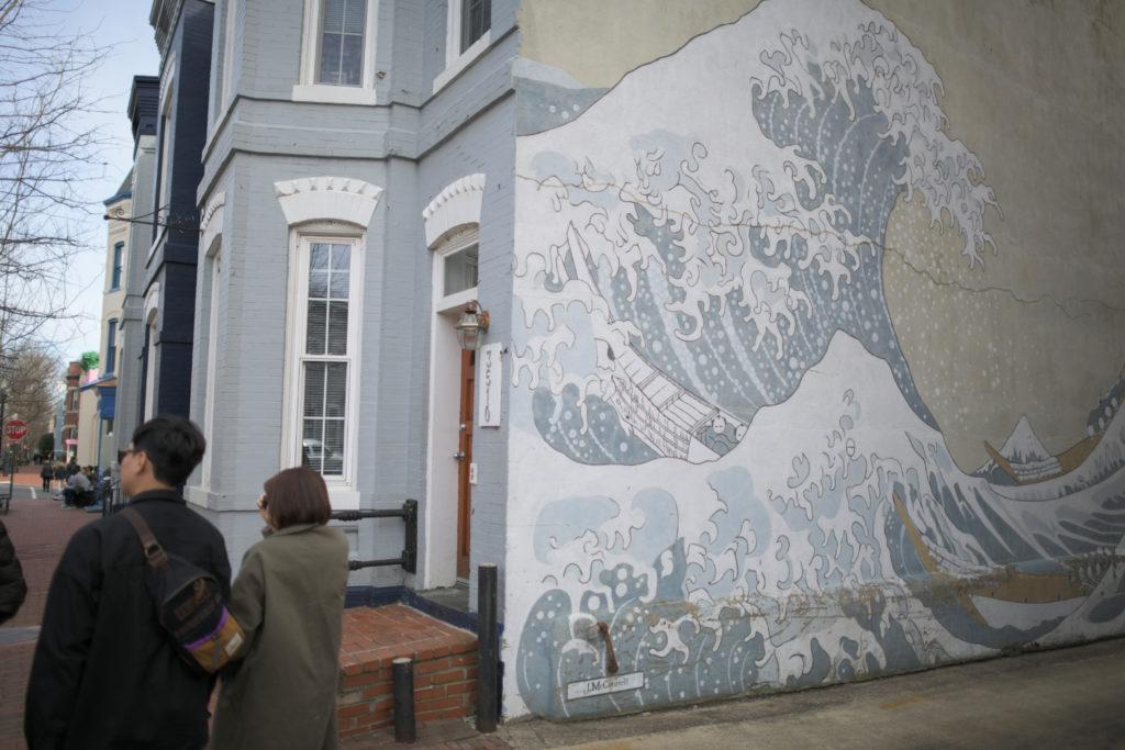 Tucked in between a row of townhouses, the immense wave mural covers the entire side of a home in Georgetown. 