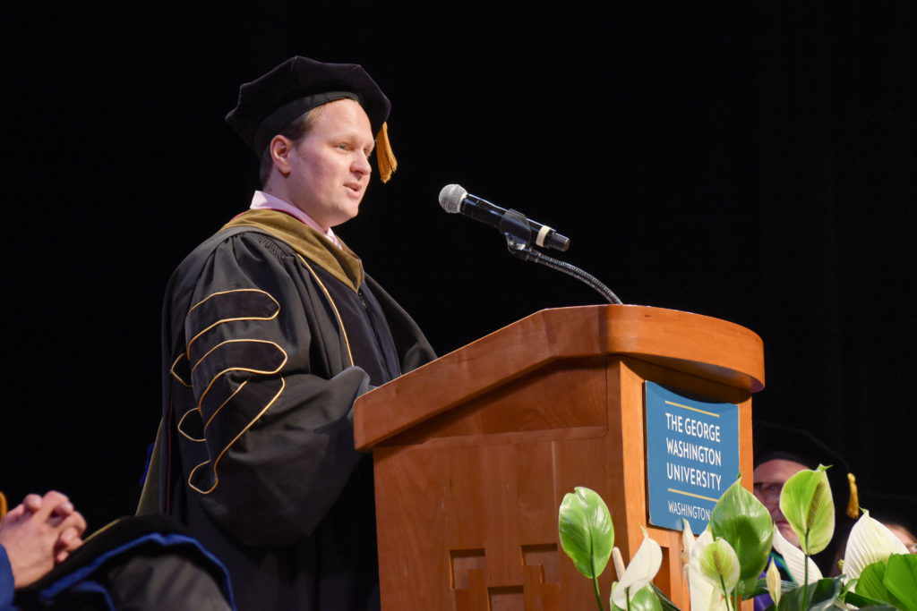 Reamer Bushardt, the medical schools senior associate dean for health sciences, tells graduates to work together to further medical knowledge and help patients.