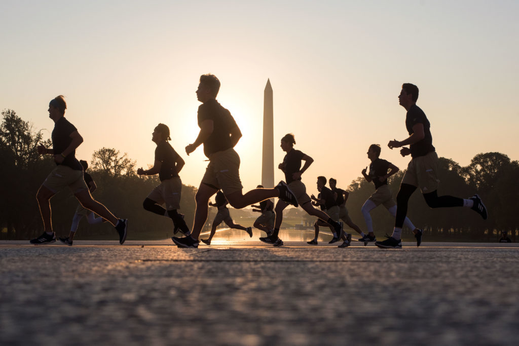 Baseball runs on the National Mall during sunrise Saturday. The squad is one of several programs that use the Mall for training. 
