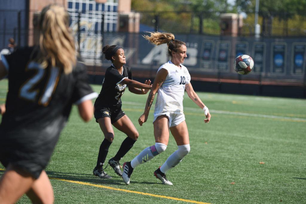 Junior+midfielder+Kelly+Amador+lunges+toward+the+ball+during+Thursdays+game+against+Towson.+Amador+scored+one+of+two+goals+and+helped+the+Colonials+end+in+a+tie+against+the+Tigers.+